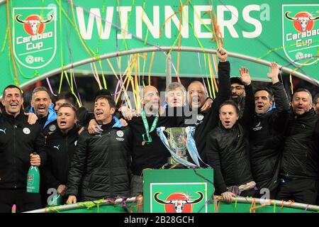 London, UK. 01st Mar, 2020. Manchester City Manager Pep Guardiola (M) celebrates with his backroom staff as they pose with the trophy after their teams win. Carabao Cup 2020 final match, Aston Villa v Manchester city at Wembley Stadium in London on Sunday 1st March 2020. this image may only be used for Editorial purposes. Editorial use only, license required for commercial use. No use in betting, games or a single club/league/player publications . pic by Steffan Bowen/Andrew Orchard sports photography/Alamy Live news Credit: Andrew Orchard sports photography/Alamy Live News Stock Photo