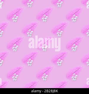 Seamless texture of pink feather and eggs on a pink background. Easter concept Stock Photo