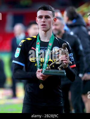 Manchester City's Phil Foden with his man of the match trophy as he celebrates after winning the Carabao Cup Final at Wembley Stadium, London. Stock Photo