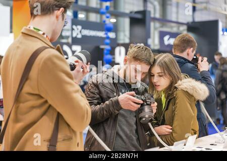 KYIV, UKRAINE - APRIL 13, 2019: People testing professional photographic cameras on Sony company booth during CEE 2019, the largest consumer electroni Stock Photo