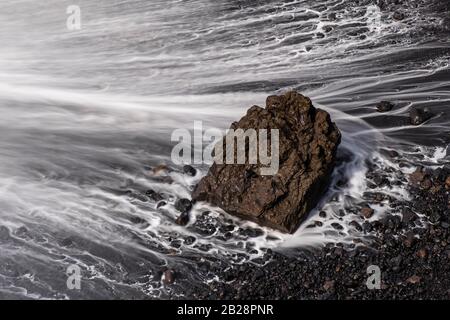 Water washes around stones, black lava sand, beach, La Palma, Canary Islands, Canary Islands, Spain Stock Photo