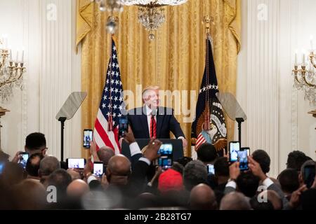 Washington, United States Of America. 27th Feb, 2020. President Donald J. Trump welcomes guests to the African American History Month Reception Thursday, Feb. 27, 2020, in the East Room of the White House People: President Donald Trump Credit: Storms Media Group/Alamy Live News Stock Photo