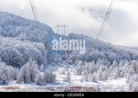 Electricity pylons in winter mountains in Bulgaria Stock Photo - Alamy
