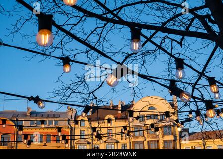 Light bulbs on the evening blue sky. Stock Photo