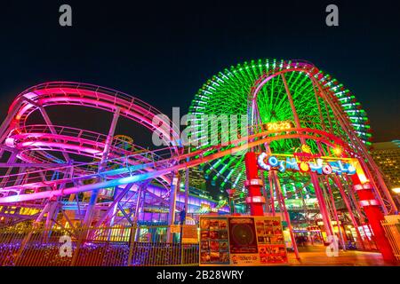Yokohama, Japan - April 21, 2017: Cosmo World amusement park in Minato Mirai 21 district of Yokohama with Cosmo Clock 21, a giant Ferris wheel, and Stock Photo