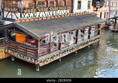 France, Restaurant in old buildings on stilts standing in river III in historical 'Petite France' quarter of city of Strasbourg Stock Photo