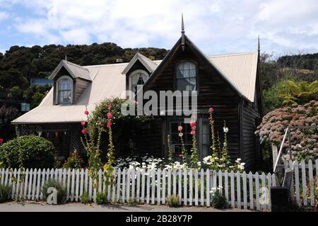 Historic old timbered 19th century cottage in Akaroa, a small historic town on the Banks Peninsula, South Island, New Zealand. Stock Photo