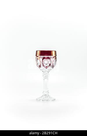 Empty crystal red patterned wine glass. Photographed in the studio on white background. Close up. Stock Photo