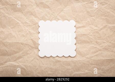 Mockup template of white cardboard card on crumpled paper. Paper layout Stock Photo