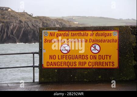 Warning sign at the quay in Rosscarbery Bay on the southwest coast of Ireland Stock Photo