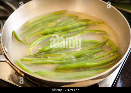 Green beans cooking on a stove Stock Photo