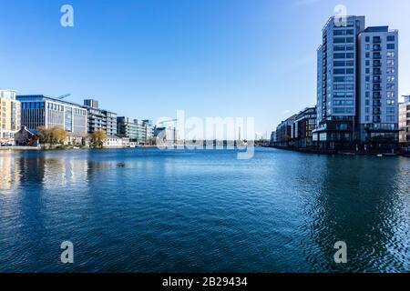 Grand Canal Docks, Ireland,  with The Millennium Tower on the right and in the distance the twin towers of Poolbeg and the Dublin Incinerator. Stock Photo