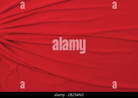 Soft red fabric draped and taken from a top down view. Great for backgrounds, textures and patterns. Stock Photo