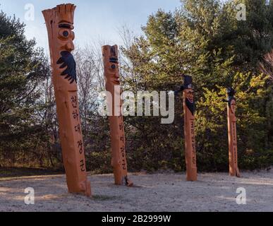 Vienna, Virginia, USA -- March 1, 2020. Traditional Korean Totem poles on display in Meadowlark Botanical Gardens. Stock Photo
