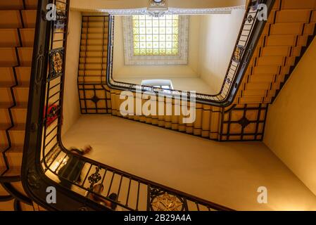 Low angle view of square staircase follow the wall and center of attic window skylight at hall or foyer in old classic building, Berliner Dom. Stock Photo