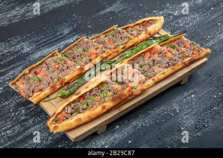 Traditional Turkish dish pita beef - Kusbasili Pide. Turkish Pide with Cube. takeaway concept Stock Photo