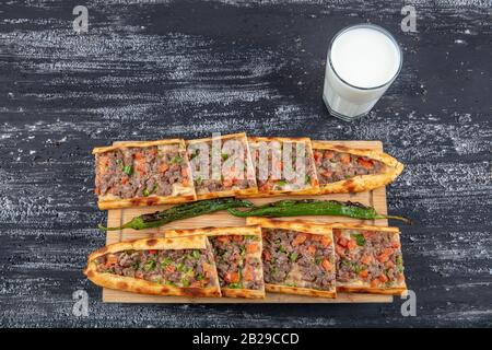 Traditional Turkish dish pita beef - Kusbasili Pide. Turkish Pide with Cube. takeaway concept Stock Photo