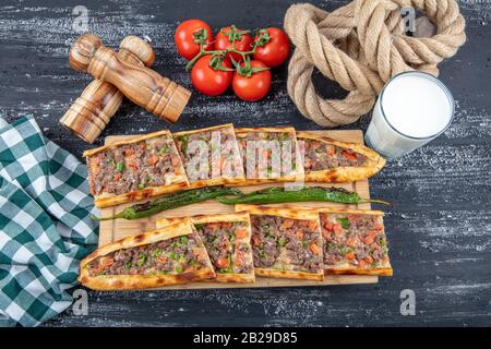 Traditional Turkish dish pita beef - Kusbasili Pide. Turkish Pide with Cube. takeaway concept Stock Photo