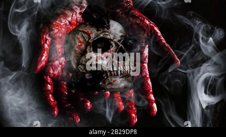 Halloween spooky skull with bloody hands and smoke Stock Photo