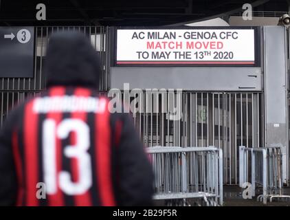 (200302) -- MILAN, March 2, 2020 (Xinhua) -- A fan of AC Milan stands outside the San Siro stadium after a Serie A soccer match between AC Milan and Genoa was postponed due to the recent coronavirus outbreak in Milan, Italy, March 1, 2020. The number of Italians infected by the coronavirus 'continues to accelerate,' Giovanni Rezza, head of the Italian High Institute of Health's Department of Infectious Diseases, said Sunday, adding that the country was at least a week away from seeing a peak in the outbreak. According to Angelo Borrelli, Civil Protection Department chief and Extraordinary Stock Photo