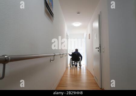 Altusried, Germany. 21st Feb, 2020. 83-year-old Irmgard Kauer drives to her room in the dementia residential community in a wheelchair. To live self-determinedly despite the illness is the aim of the community (to dpa-KORR: 'Here my mother can be a human being' - everyday life in a dementia shared flat'). Credit: Karl-Josef Hildenbrand/dpa - ATTENTION: Only for editorial use in connection with current reporting and only with complete mention of the above credit/dpa/Alamy Live News