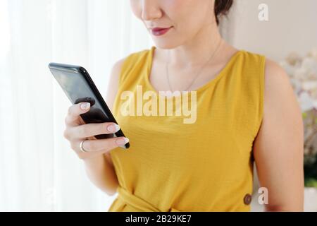 Close-up image of woman checking messages and notifications on smartphone Stock Photo