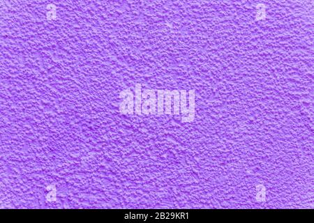 Purple decorative plaster. The texture of the plaster woodworm. Abstract rough background. Decorative stucco.Ultra Violet plastered wall texture Stock Photo