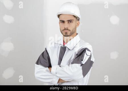 smart pensive builder thinking about something indoors Stock Photo