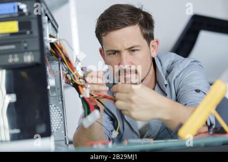 man fix server network in data center room Stock Photo