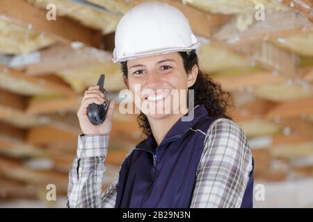 female construction worker using walkie talkie Stock Photo