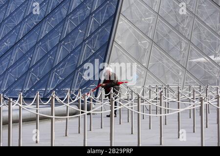 Paris. 11th Mar, 2019. File photo taken on March 11, 2019 shows a man standing in front of the Louvre Museum in Paris, France. The Louvre Museum was shut down on March 1 due to the spreading coronavirus epidemic. Credit: Gao Jing/Xinhua/Alamy Live News Stock Photo