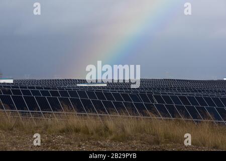rainbow and photovoltaic panels of a solar power station