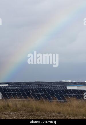 rainbow and photovoltaic panels of a solar power station