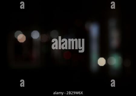 Light spots round multi-colored in the night on a dark background glow, shine. Garland. Stock Photo