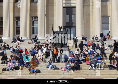 Students (and Alma Mater) lounging on the steps of the old Columbia University Library on a warm winter day, February 24, 2020, New York, NY. Stock Photo