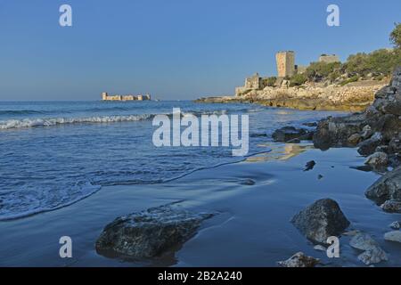 The Maiden's Tower (Turkish: Kız Kulesi) or Kizkalesi on island in sea. Corycus ruins in foreground. Turkey. Stock Photo