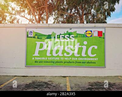 Banner ad in parking at LIDL supermarket call customers to use less plastic and removes plastic from shelves: Hamrun, Malta - February 3, 2020 Stock Photo