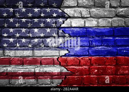 Closeup, flags of Usa against Russia on a cracked brick wall background. Concept of crisis of war and political conflicts between nations Stock Photo