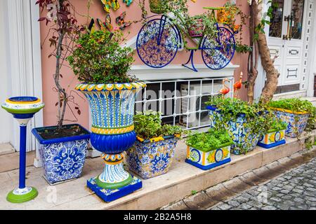 Colourful ceramic planters, ornaments and a bicycle outside a building in Istanbul, Turkey Stock Photo