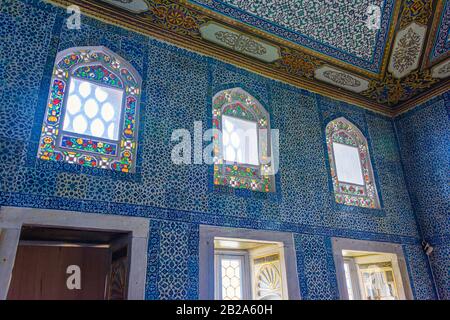 Ornate ceramic wall tiles and stained glass windows at the Topkapi Palace Museum, Istanbul, Turkey Stock Photo