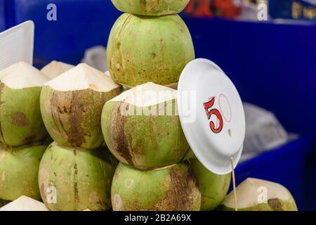 Coconuts on sale at a treet food restaurant, Bangkok, Thailand Stock Photo