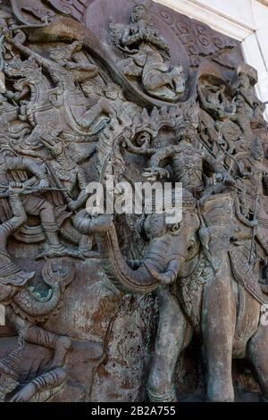 Ornately carved Hindu battle scene with Indra, the god of rain and thunderstorms, riding his elephant Airavata at Wat Songkhram, Bangkok, ThailandIndr Stock Photo