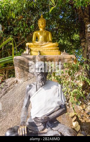 Statue of a Golden Buddha and a Buddhist Monk, Thailand Stock Photo