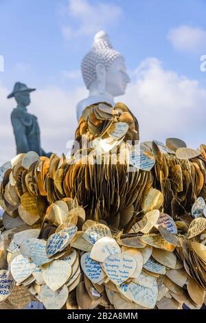 Messages of peace and love written on bronze hearts at the Big Buddha, Phuket, Thailand Stock Photo