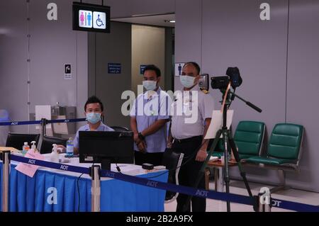 Health officials wearing face masks man the Thermoscan at Suvarnabhumi Airport during the Coronavirus epidemic. Bangkok Thailand. © Kraig Lieb Stock Photo
