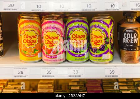 Tins of Chupa Chups fizzy soft drinks for sale in a supermarket. Stock Photo