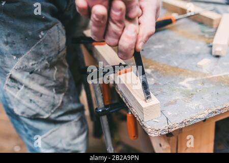 Manual processing of wood in the carpentry workshop - craft production Stock Photo