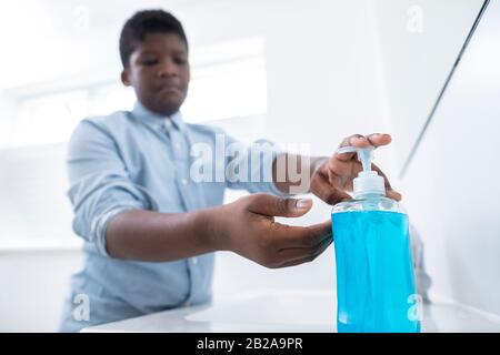 Boy Washing Hands With Soap At Home To Prevent Infection Stock Photo