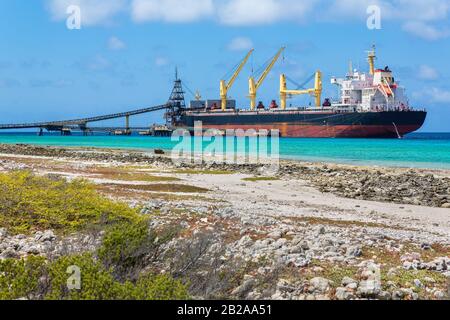 Loading of salt into a freighter on the coast of island Bonaire Stock Photo