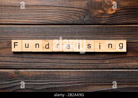 fundraising word written on wood block. fundraising text on table, concept. Stock Photo